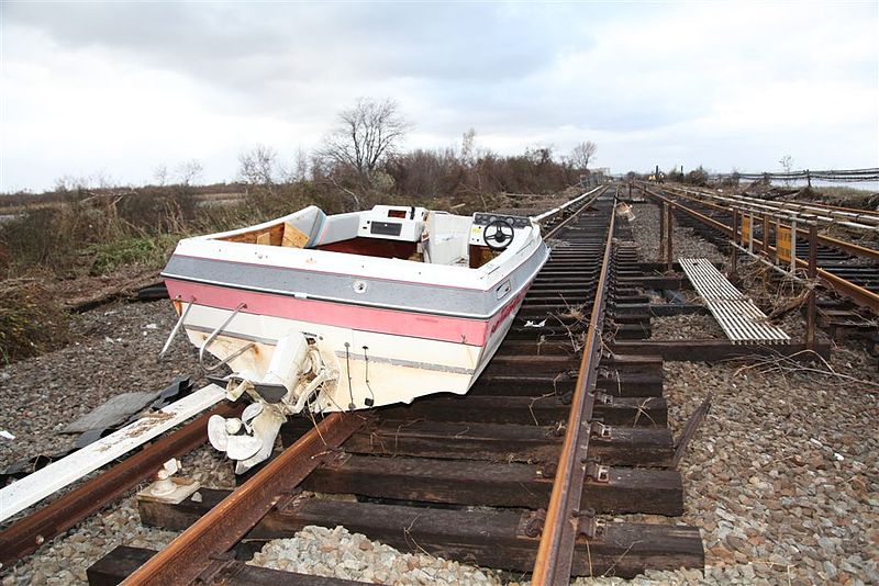 a delapidated boat washed up on to train tracks